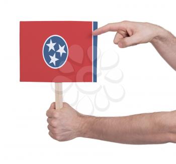 Hand holding small card, isolated on white - Flag of Tennessee