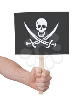 Hand holding small card, isolated on white - Flag of Pirate