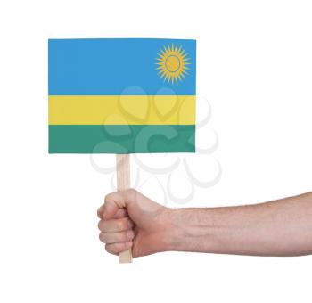 Hand holding small card, isolated on white - Flag of Rwanda