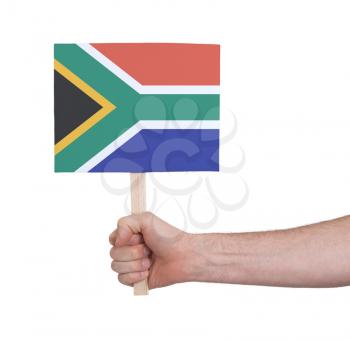 Hand holding small card, isolated on white - Flag of South Africa