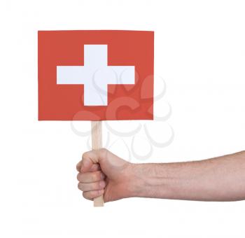 Hand holding small card, isolated on white - Flag of Switzerland