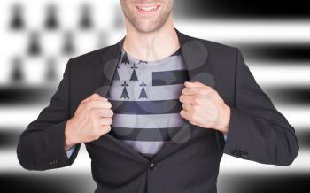 Businessman opening suit to reveal shirt with flag, Brittany