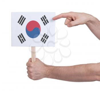 Hand holding small card, isolated on white - Flag of South Korea