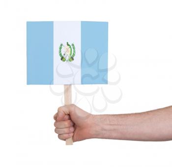 Hand holding small card, isolated on white - Flag of Guatemala