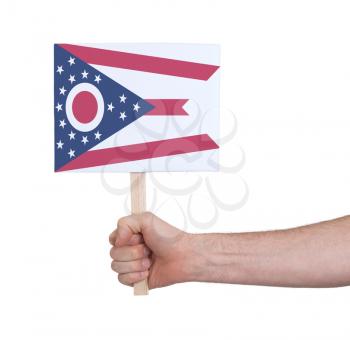 Hand holding small card, isolated on white - Flag of Ohio