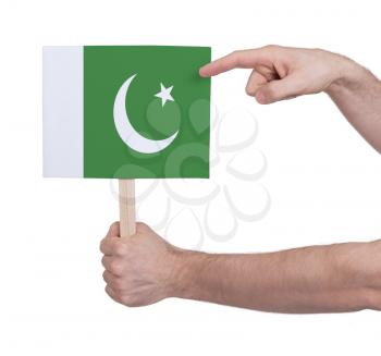 Hand holding small card, isolated on white - Flag of Pakistan