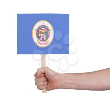Hand holding small card, isolated on white - Flag of Minnesota