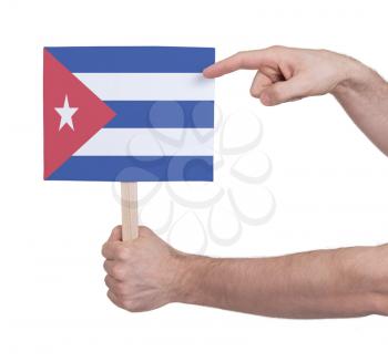 Hand holding small card, isolated on white - Flag of Cuba