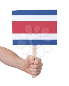 Hand holding small card, isolated on white - Flag of Costa Rica