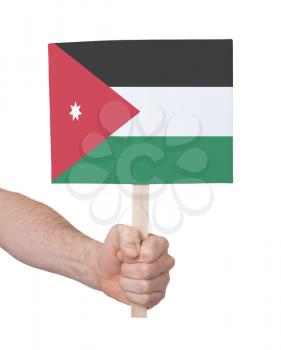 Hand holding small card, isolated on white - Flag of Jordan
