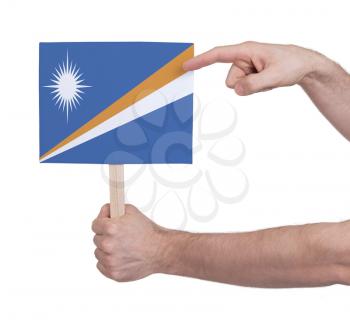 Hand holding small card, isolated on white - Flag of Marshall Islands