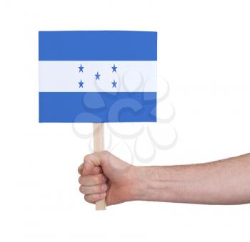 Hand holding small card, isolated on white - Flag of Honduras