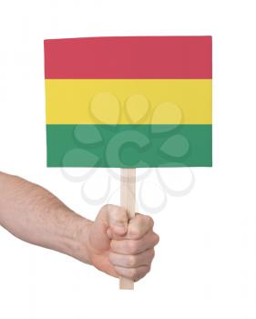 Hand holding small card, isolated on white - Flag of Bolivia