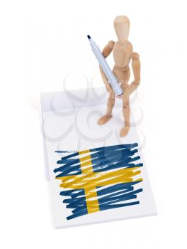 Wooden mannequin made a drawing of a flag - Sweden