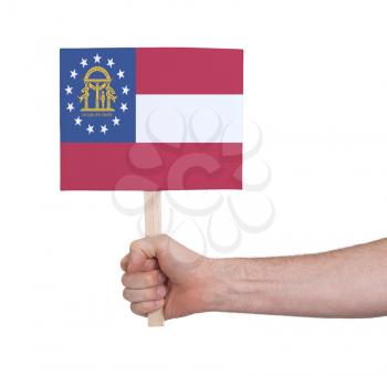 Hand holding small card, isolated on white - Flag of Georgia