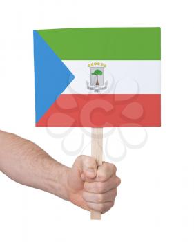 Hand holding small card, isolated on white - Flag of Equatorial Guinea