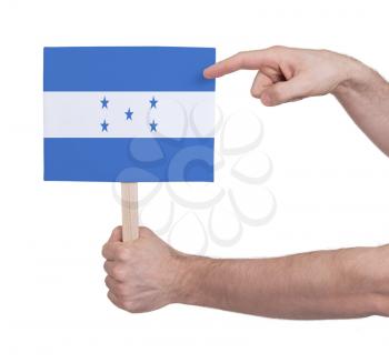 Hand holding small card, isolated on white - Flag of Honduras