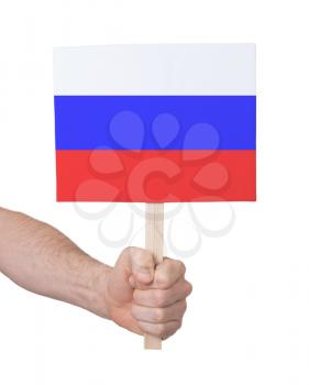 Hand holding small card, isolated on white - Flag of Russia