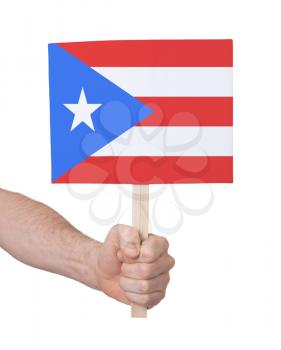 Hand holding small card, isolated on white - Flag of Puerto Rico