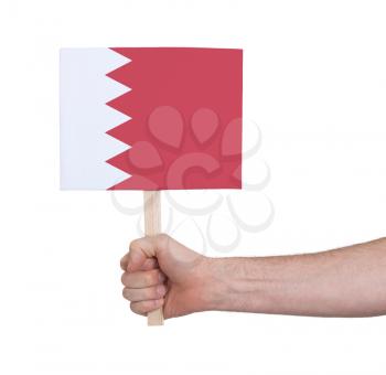 Hand holding small card, isolated on white - Flag of Bahrain