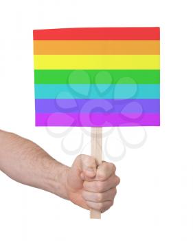 Hand holding small card, isolated on white - Flag of Rainbow flag