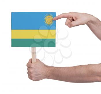 Hand holding small card, isolated on white - Flag of Rwanda