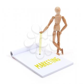 Wooden mannequin writing in a scrapbook - Marketing