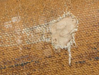 Detail (damage) of an old canvas suitcase, close-up, vintage look