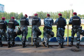 policemen standing guard over order in the stadium during football match