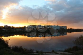 beautiful landscape with sunset, river and modern house reflecting in it