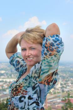 blue-eyed sympathetic girl on the background of view of city