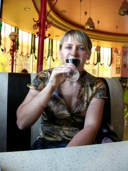 the girl with glass of red wine in restaurant