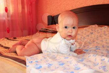little lovely baby lying on the bed