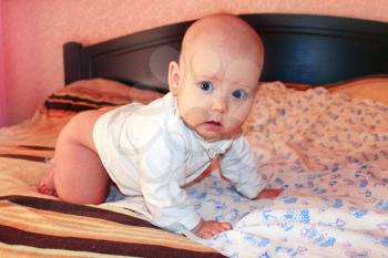 little lovely baby lying on the bed in marvellous pose