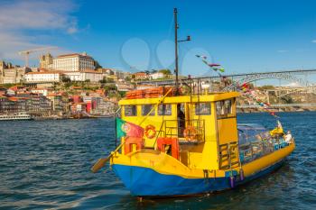 Tourist boat and Douro River in Porto in a beautiful summer day, Portugal