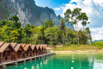 Traditional Thai bungalows at Cheow Lan lake, Ratchaprapha Dam, Khao Sok National Park in Thailand in a summer day