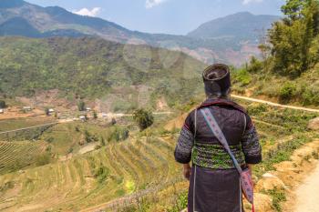 Woman wearing traditional clothes at Terraced rice field in Sapa, Lao Cai, Vietnam in a summer day