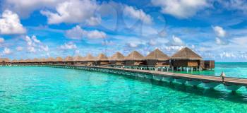 Panorama of Water Villas (Bungalows) at Tropical beach in the Maldives at summer day