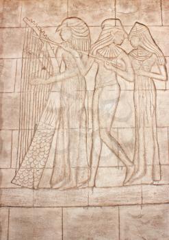 Old murals. Frieze of Egyptian Goddess. Wall carving.