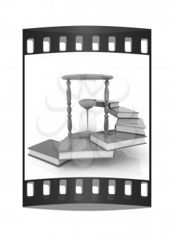 Hourglass and books on a white background. The film strip