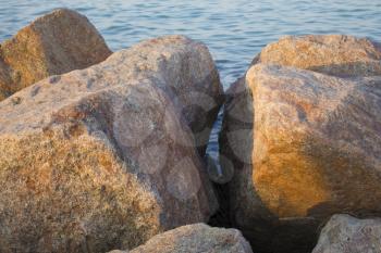 Boulders and the sea at sunset