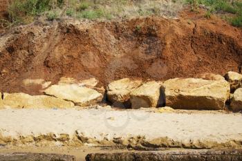 the surface texture of the slope from dry sand-clay granular soils with a reddish tinge