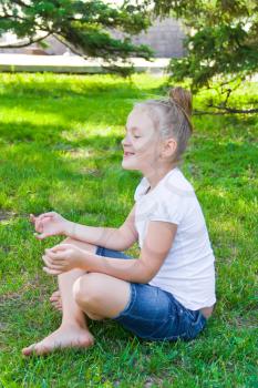 Photo of cute girl in lotus pose