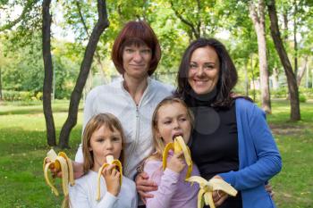 Photo of group people are eating bananas in summer