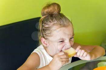 Photo of the cute girl eating melon
