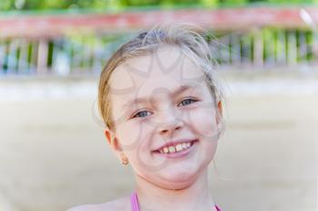 Smiling cute girl with blond hair and blue eyes