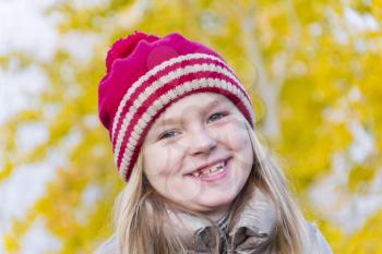 Portrait of cute smiling girl in red hat