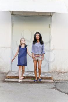 Photo of walking mother and daughter in summer