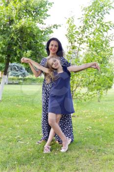 Playing mother and daughter in summer on green background