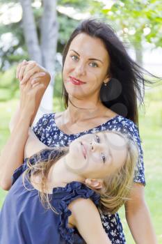 Playing mother and daughter in summer on green background